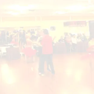 a group of people dancing in a ballroom