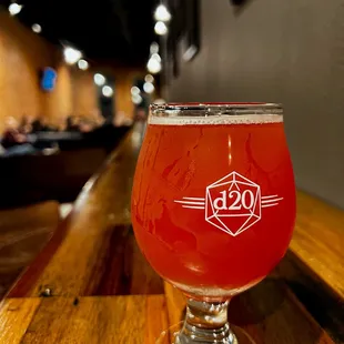 a glass of beer on a wooden table