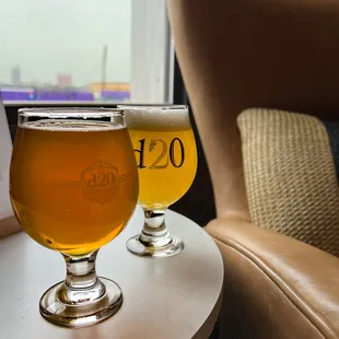 two glasses of beer on a table