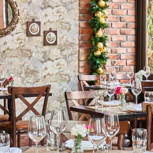 a dining room with a brick wall