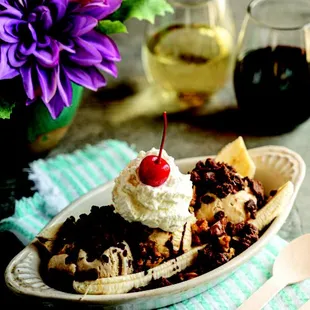 a banana split with ice cream and a cherry