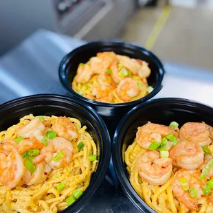 three bowls of shrimp and noodles