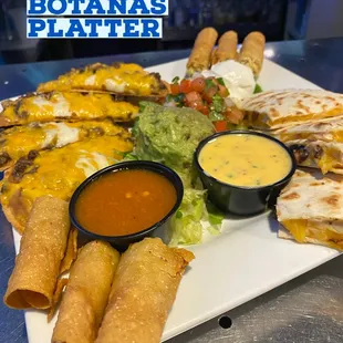 Tex Mex platter including hand made taquitos, quesadillas, and nachos.