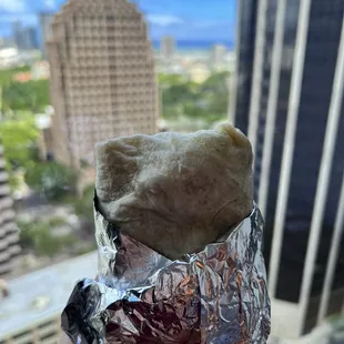 a hand holding a burrito