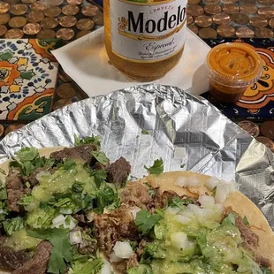 a bottle of beer and a plate of food