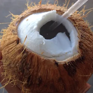a coconut with a straw