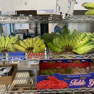 a display of bananas and strawberries