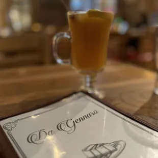 a drink and a menu on a table