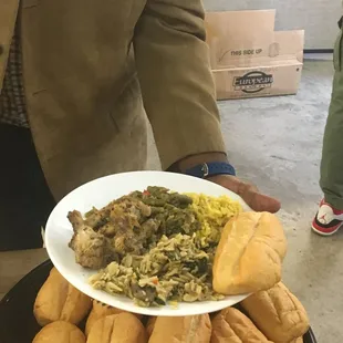 Drumettes and chicken wings, green peas and yellow rice with french bread pistolette