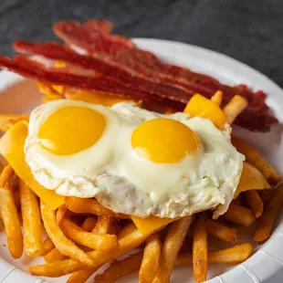 a plate of french fries and eggs