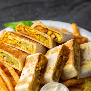 a plate of quesadillas and french fries