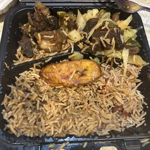 Brown Stew Chicken with cabbage and plantains. No gravy on my rice like I asked and was told it was gravy, a lot of gravy on my rice.
