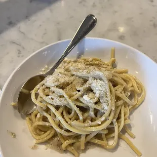 a plate of pasta with a spoon