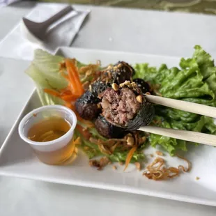 a plate of food with chopsticks