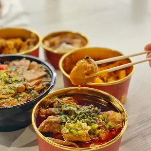 bowls of chinese food with chopsticks