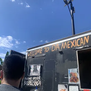 a man standing in front of a food truck