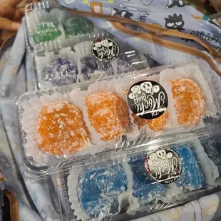 a variety of donuts in plastic containers