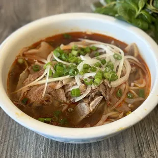 a bowl of beef and noodles