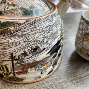 a teapot and a cup on a table