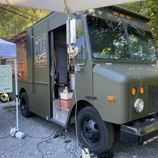 a food truck parked under an umbrella