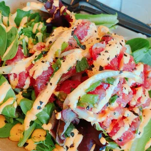 Spicy poke over greens
