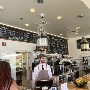 a bari serving customers in a coffee shop