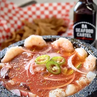 CHIPILON Cooked shrimp, shrimp crudo, octopus, fish crudo,  onion, serranos, cucumber in Cartel Sauce. Served w/ homemade chips 17.95