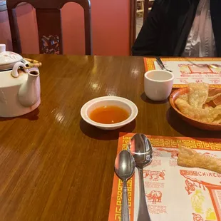 a man sitting at a table with a bowl of soup and a plate of food