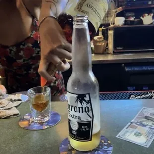 a woman pouring a beer into a glass