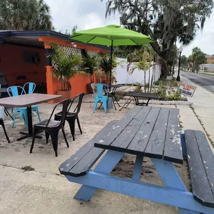 a picnic table and chairs on a sidewalk
