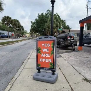 a sign that says yes we are open