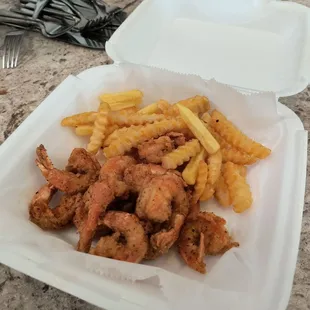a container of fried chicken and french fries