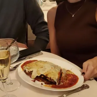 a woman sitting at a table with a plate of food