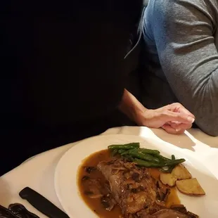 a woman sitting at a table with a plate of food