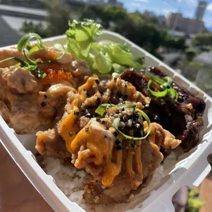a hand holding a container of food