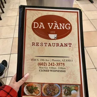 a person holding a menu