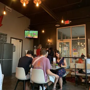 a group of people sitting at a table in a restaurant
