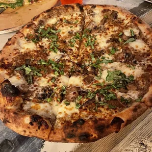 Truffle Funghi Pizza (truffle oil, garlic paste, fior di latte, Italian sausage, roasted mushrooms, basil)