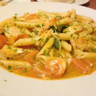 a plate of pasta with shrimp and vegetables