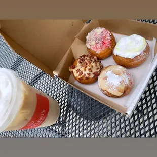 a box of donuts and a cup of coffee