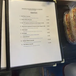 Menu at register station in the restaurant.