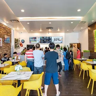 a large group of people eating in a restaurant