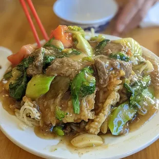 a plate of food with chopsticks