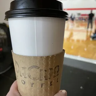 a hand holding a coffee cup