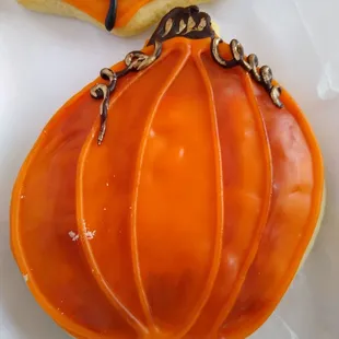 two decorated pumpkin cookies