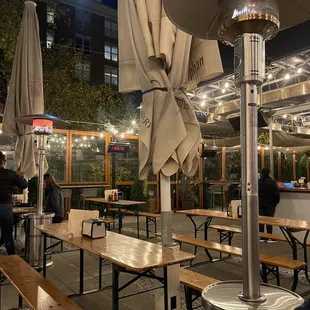 a patio with tables and umbrellas