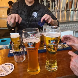 a man pouring a pint of beer