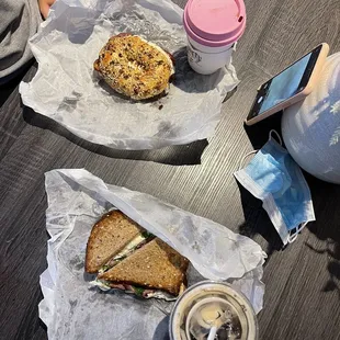 Bacon and egg bagel, egg white turkey bacon and arugula sandwich with hot coffee and cold brew