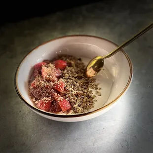 a bowl of granola with strawberries