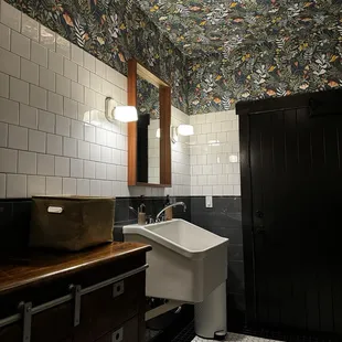 a bathroom with black and white tiles